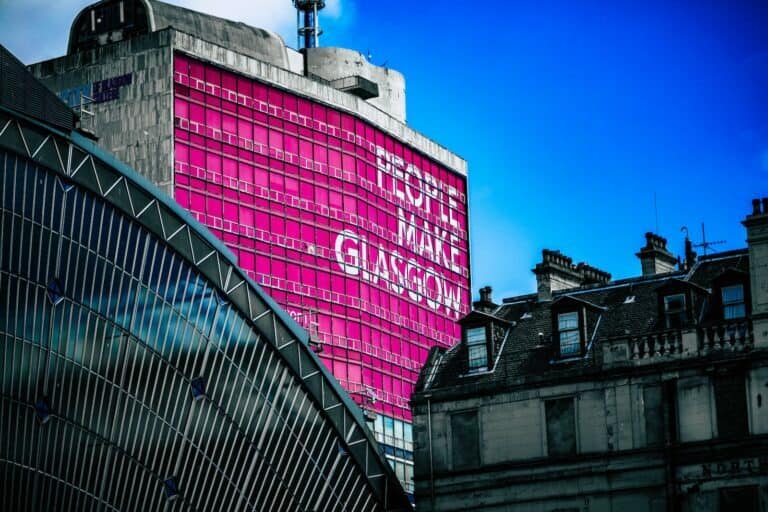 low angle view of building with People make Glasgow billboard
